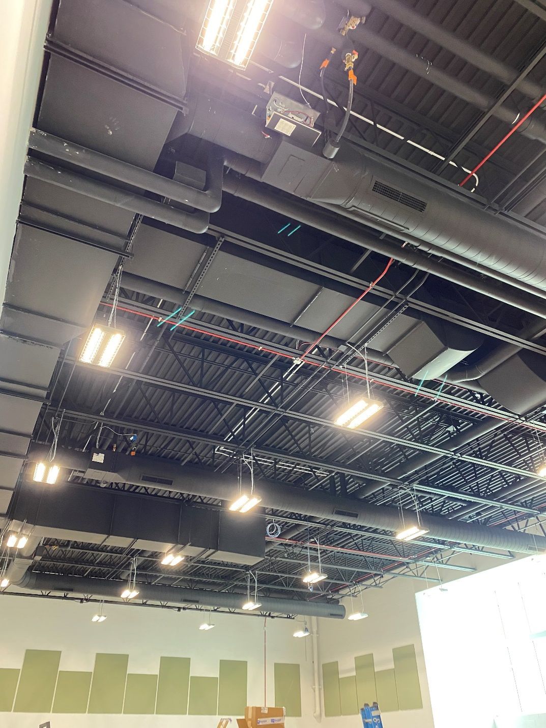 The ceiling of a building with a lot of lights on it.