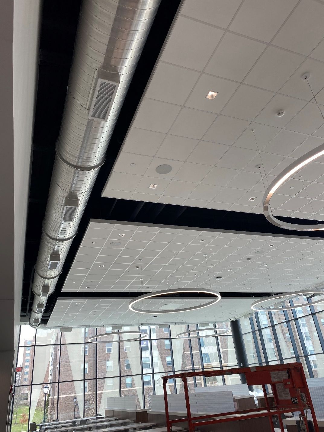 A large room with a ceiling that has a lot of pipes coming out of it.