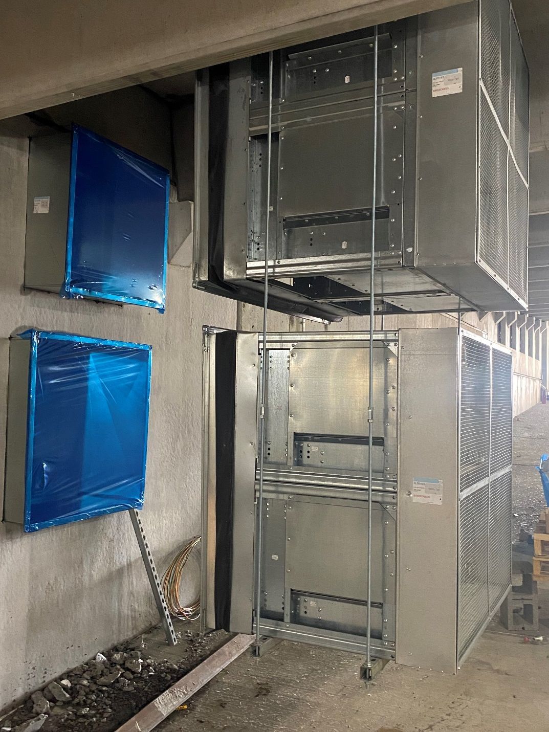 A room with a lot of metal boxes on the wall.