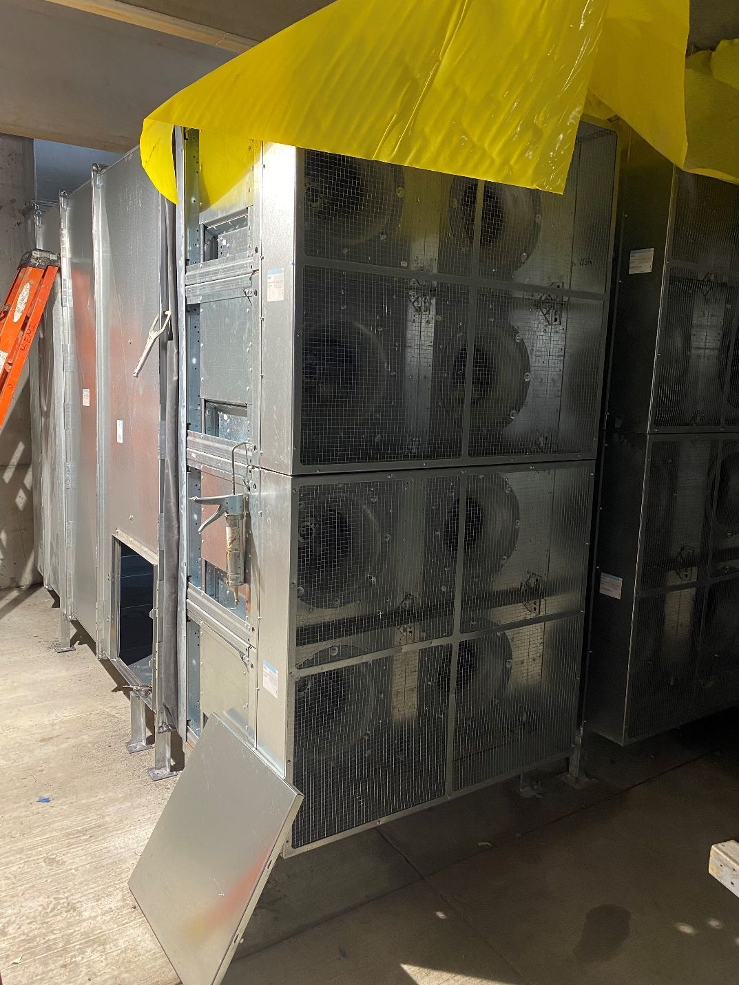 A large metal structure with a yellow tarp on top of it.