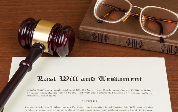 A gavel is sitting on top of a last will and testament.