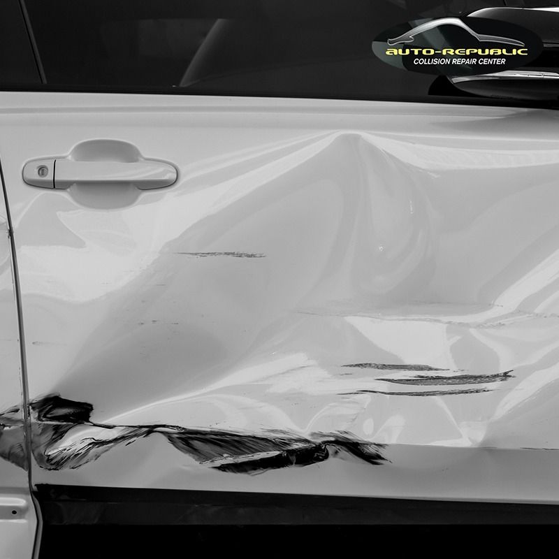 A white car with a sticker that says auto republic