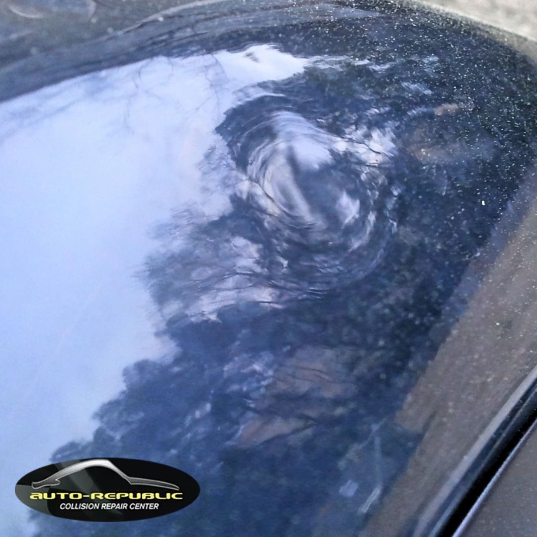 A close up of a car windshield with a logo for auto republic