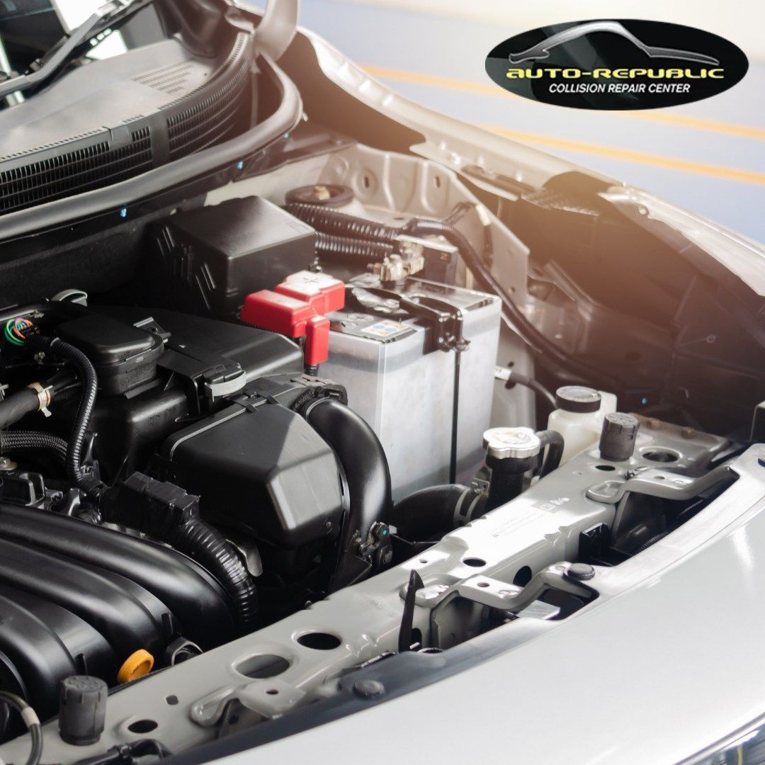 A close up of a car engine with the hood open for auto republic