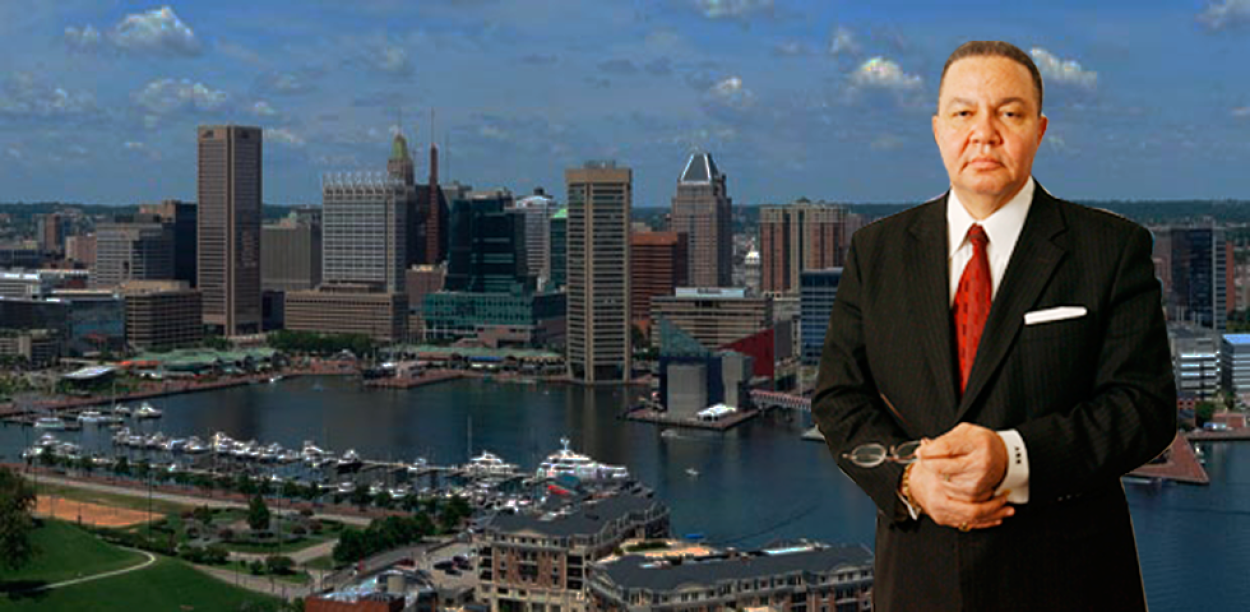 A. Dwight Pettit in front of a cityscape background