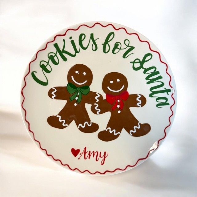 Round plate with “Cookies for Santa” and two gingerbread cookies, one green-bowed and one red-bowed, signed “Amy”