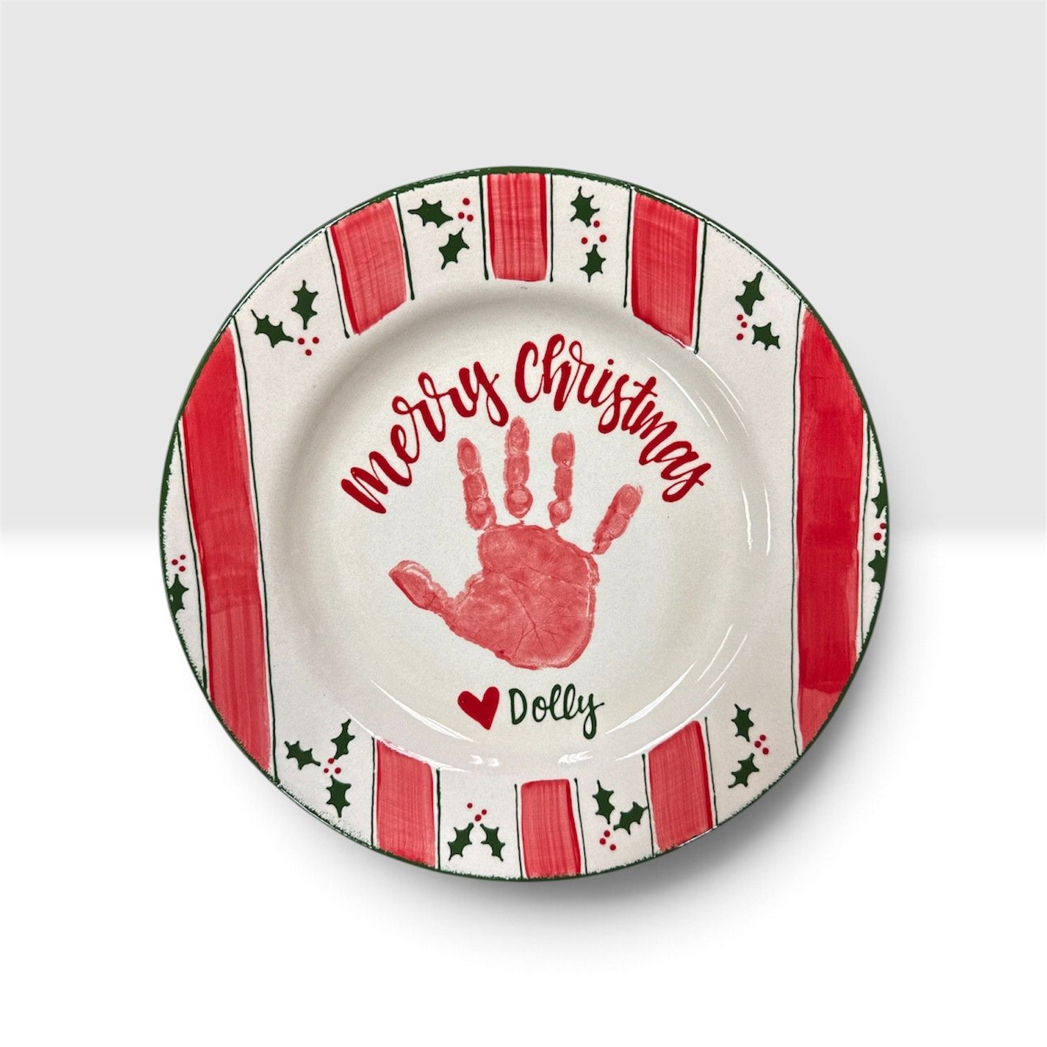 Festive plate with red handprint, “Merry Christmas,” heart, and candy cane border