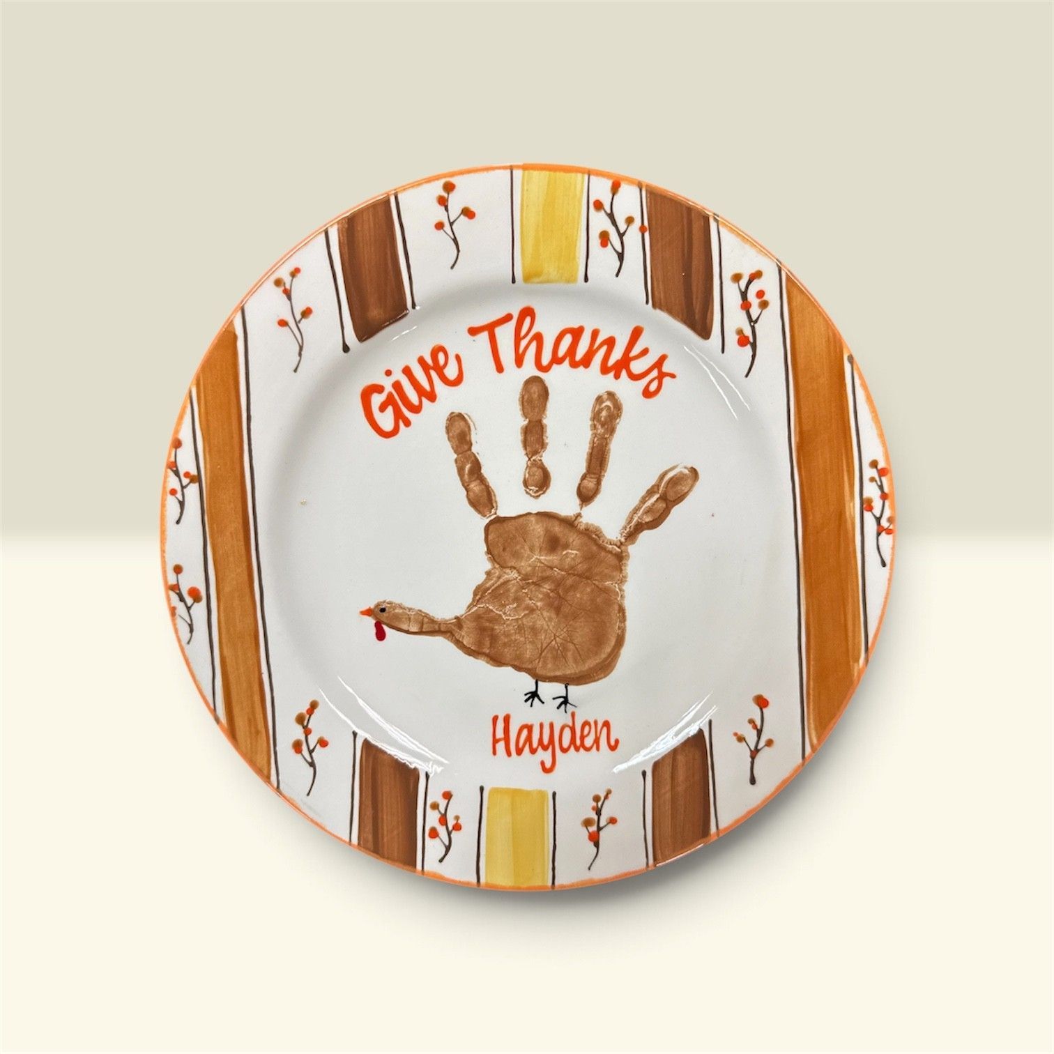 “Give Thanks” plate with a brown handprint and autumn leaf border, personalized with “Hayden”