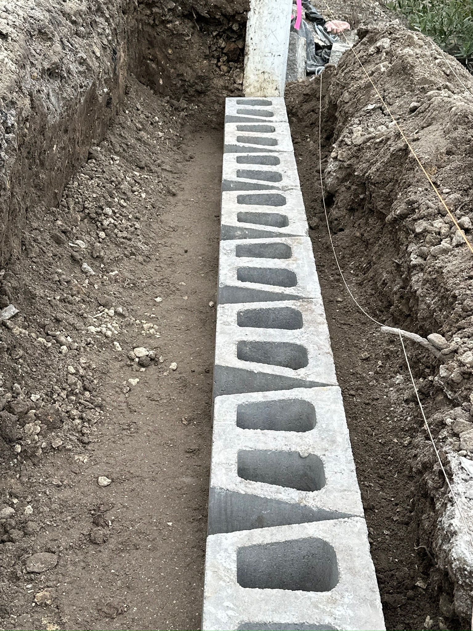 Concrete blocks placed in a trench. Construction site.