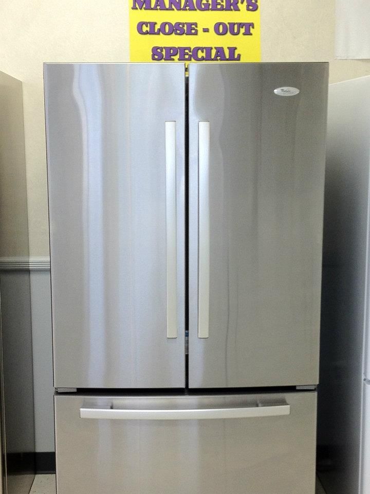 Stainless steel Whirlpool refrigerator with three doors;