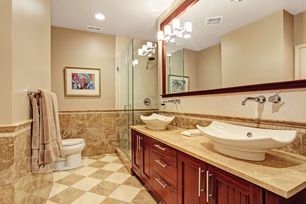 A bathroom with two sinks , a toilet , and a large mirror