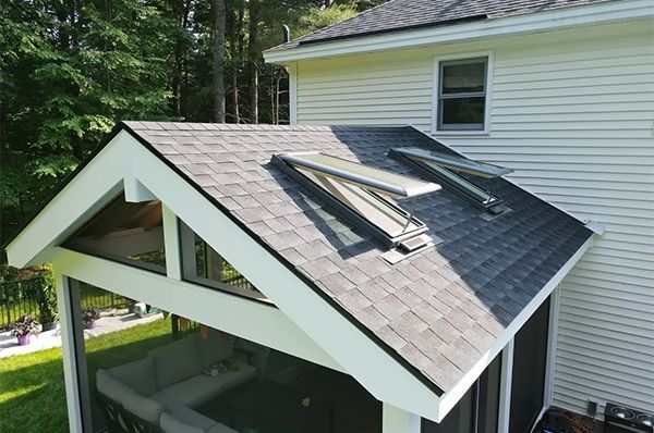 Learn More About Velux Skylights Back of house roof with two skylights and a white gable over a screened porch