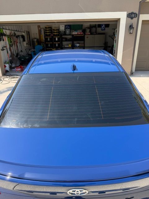Blue Toyota sedan parked in a garage, rear window visible
