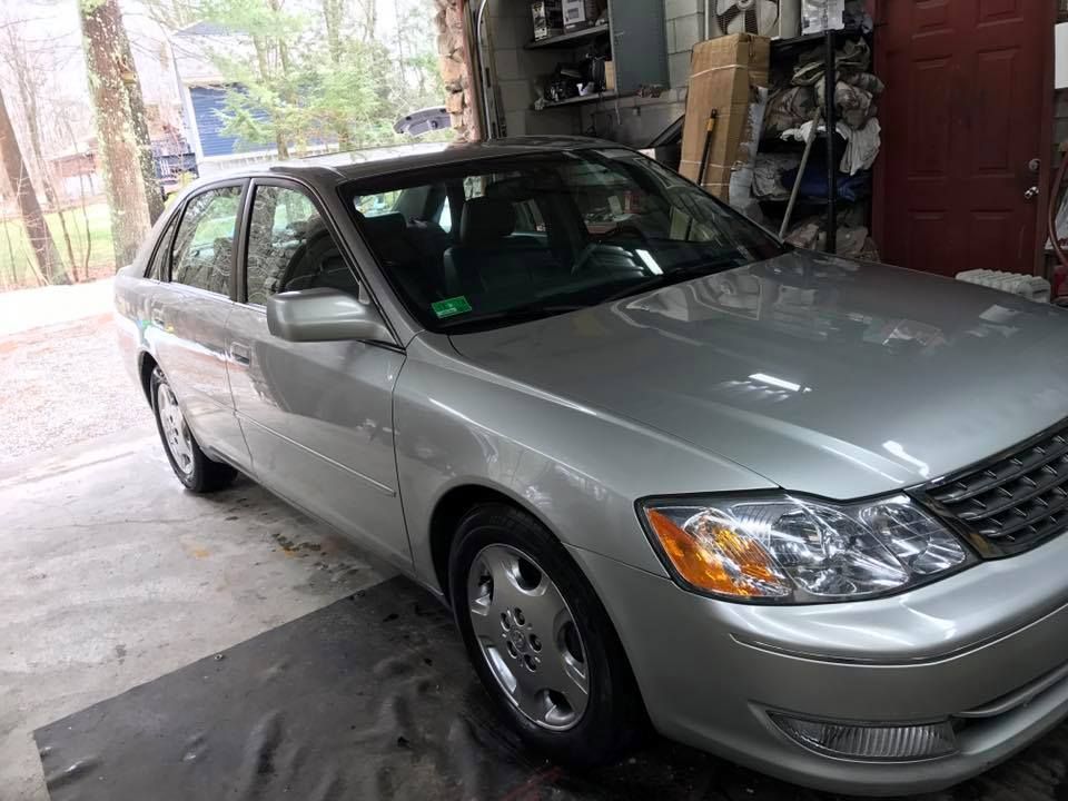 A silver car is parked in a garage.