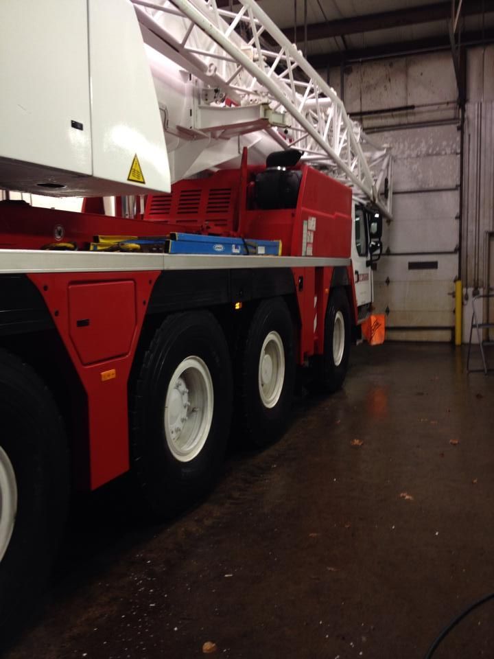 A red and white ladder truck is parked in a garage