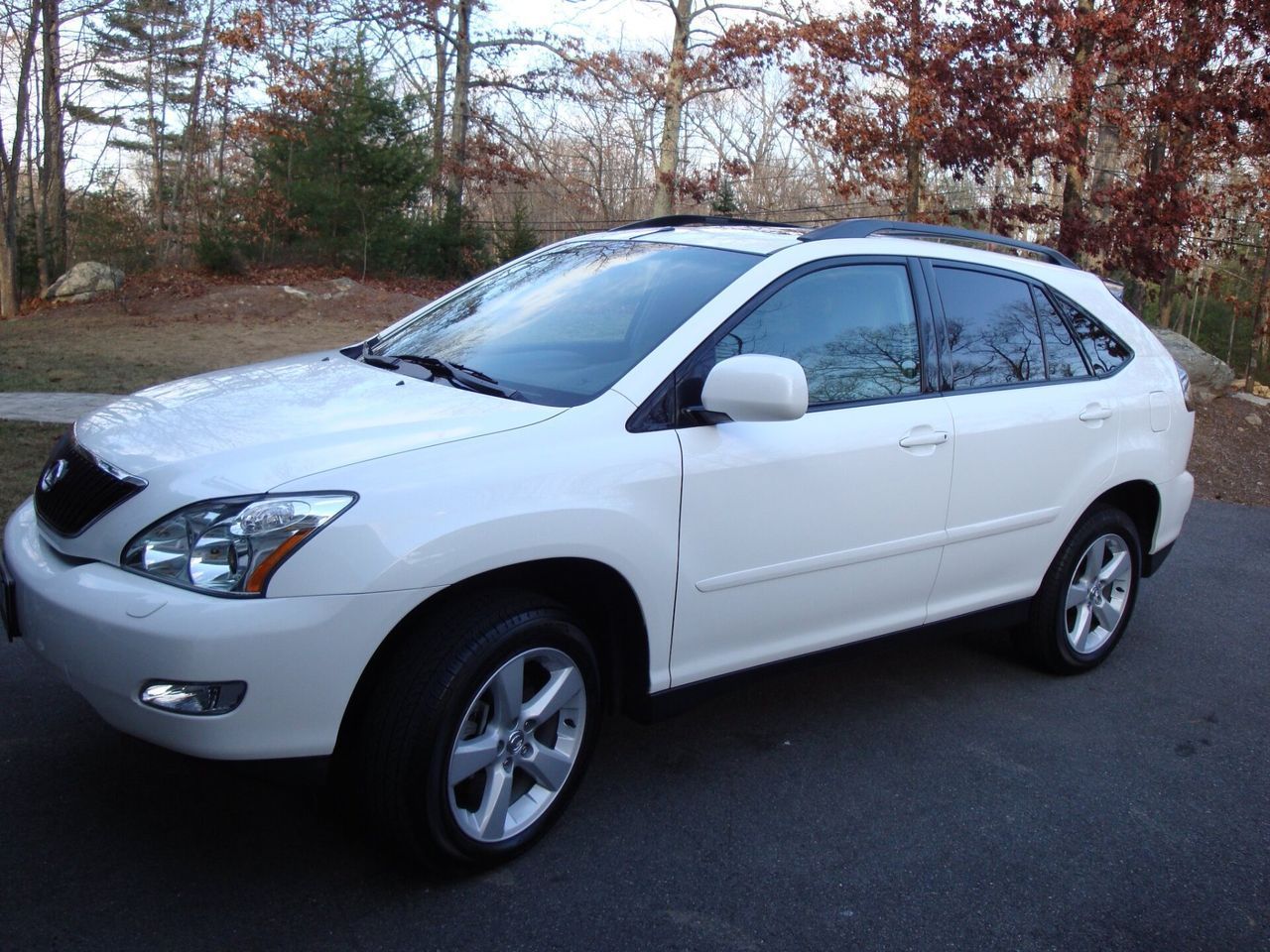 A white suv is parked on the side of the road