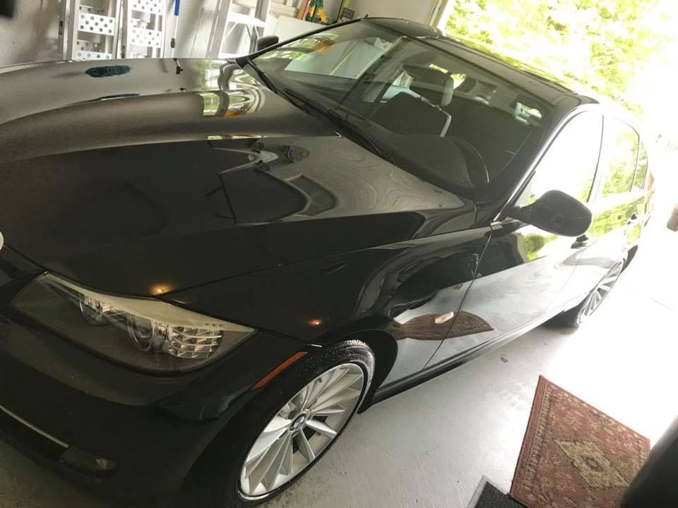 A black car is parked in a garage.