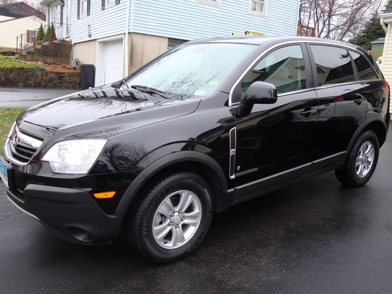 A black suv is parked in front of a house