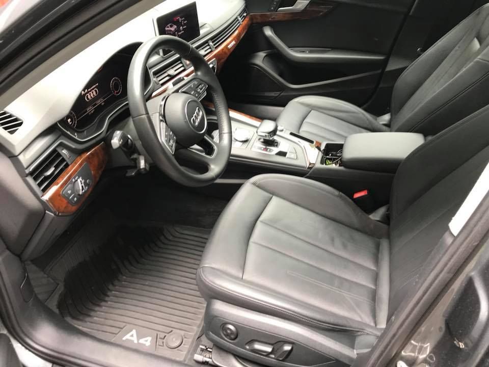The interior of an audi a4 with black leather seats