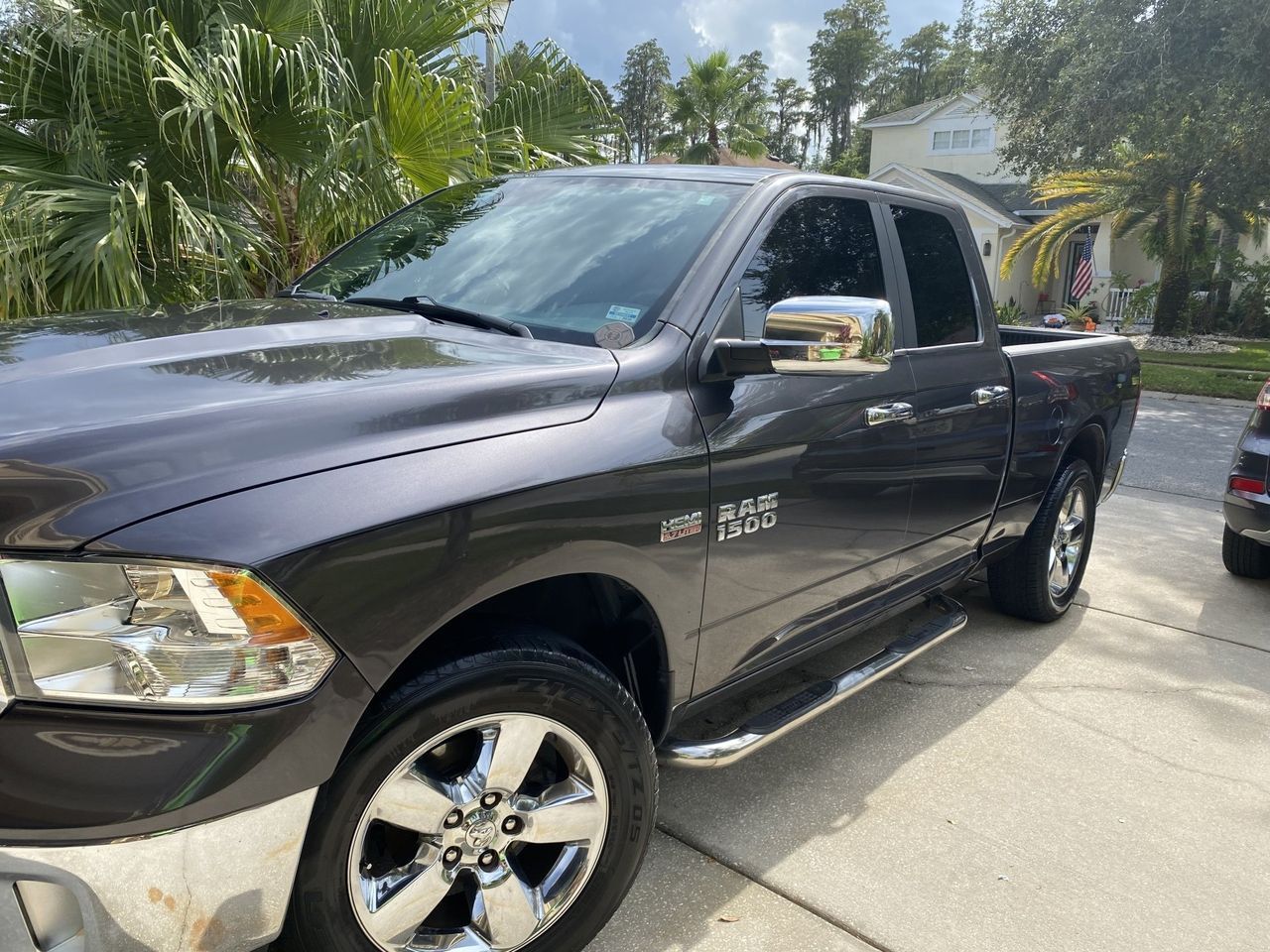 A black dodge ram truck is parked in a driveway.