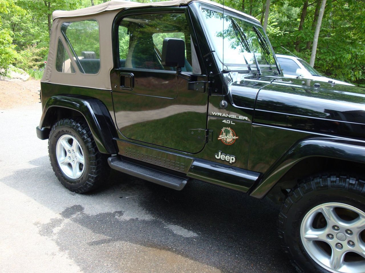A black jeep is parked on the side of the road