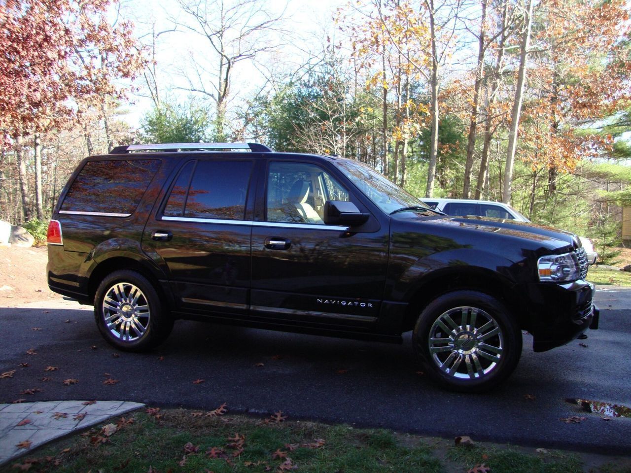 A black ford expedition is parked on the side of the road