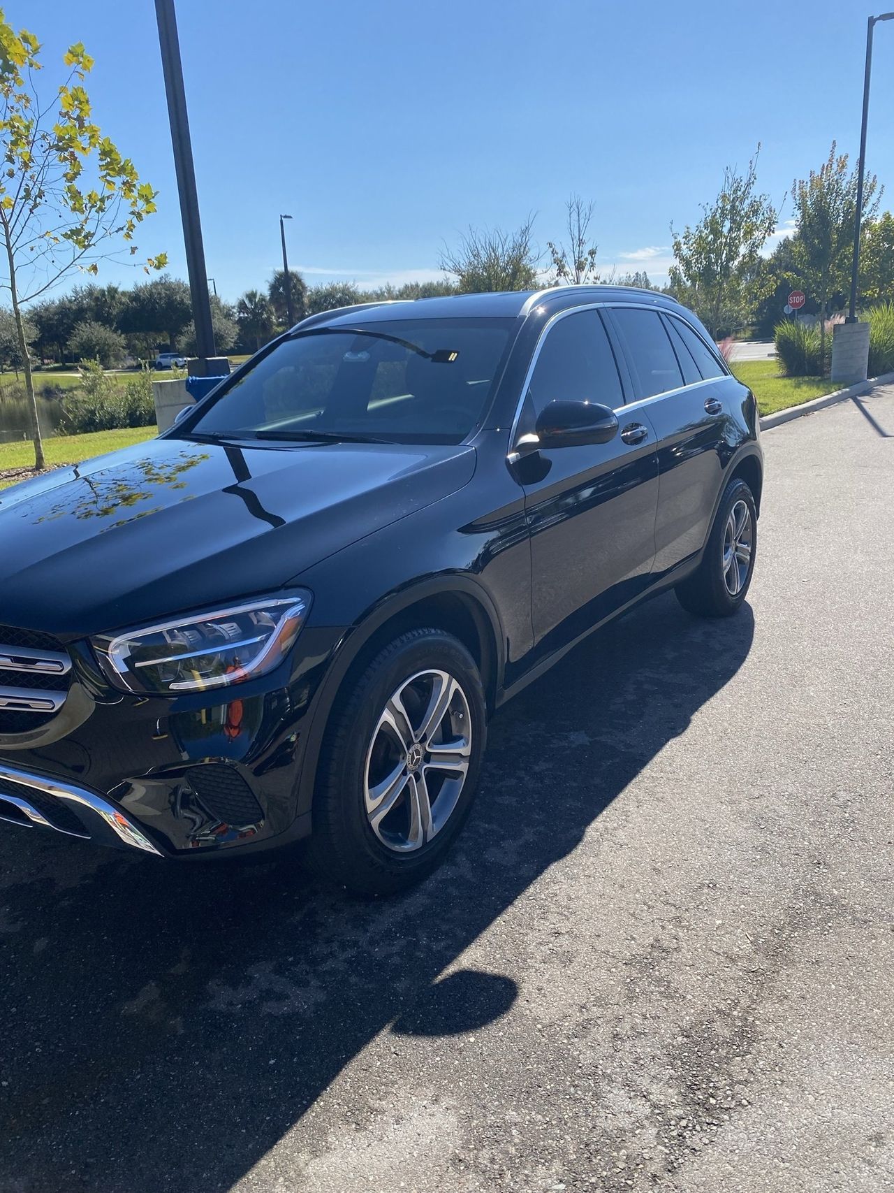 A black suv is parked on the side of the road.