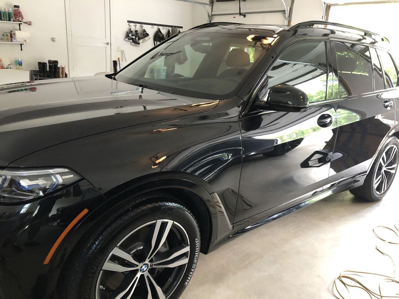 A black bmw x5 is parked in a garage.