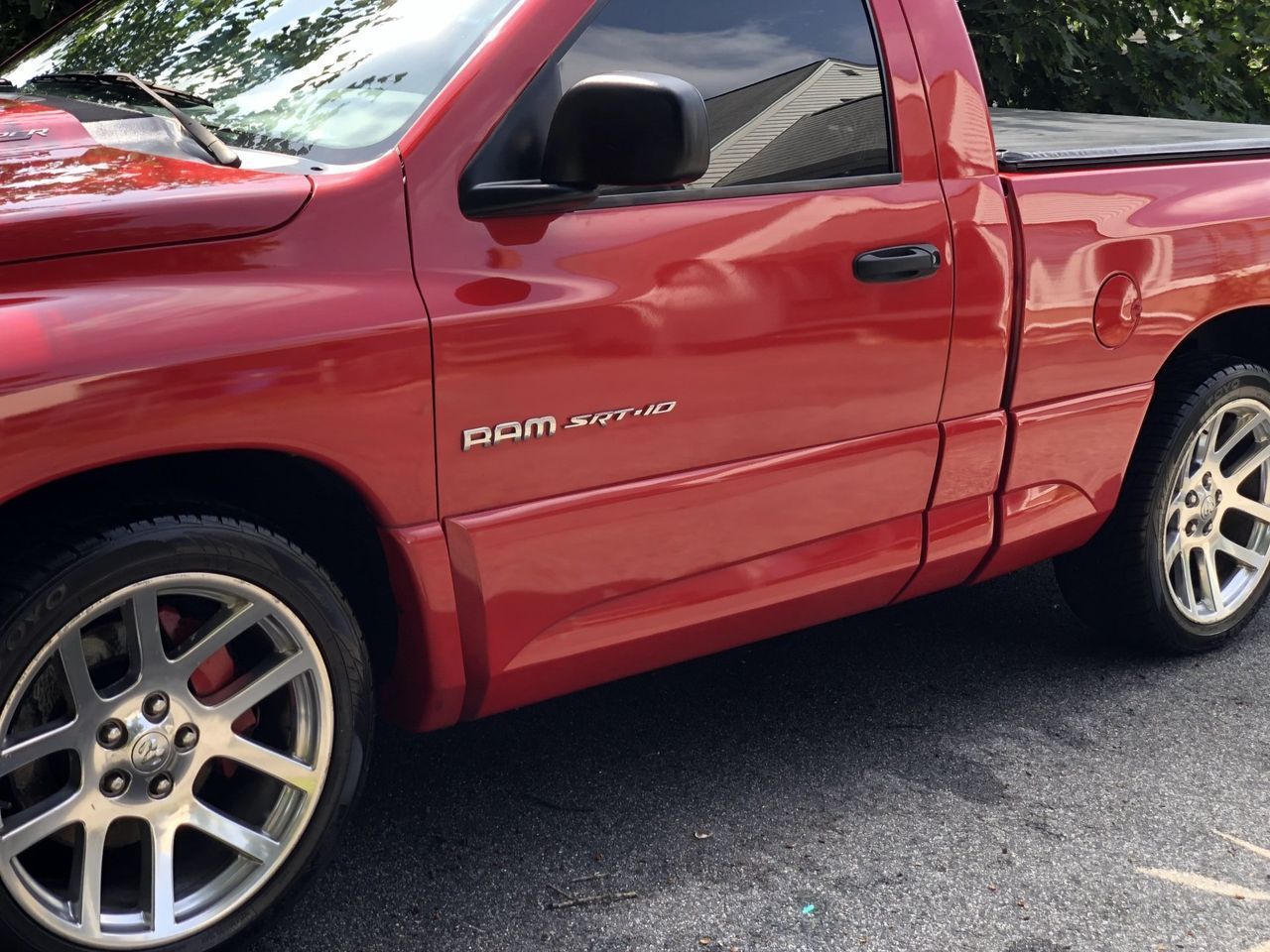A red dodge ram truck is parked on the side of the road
