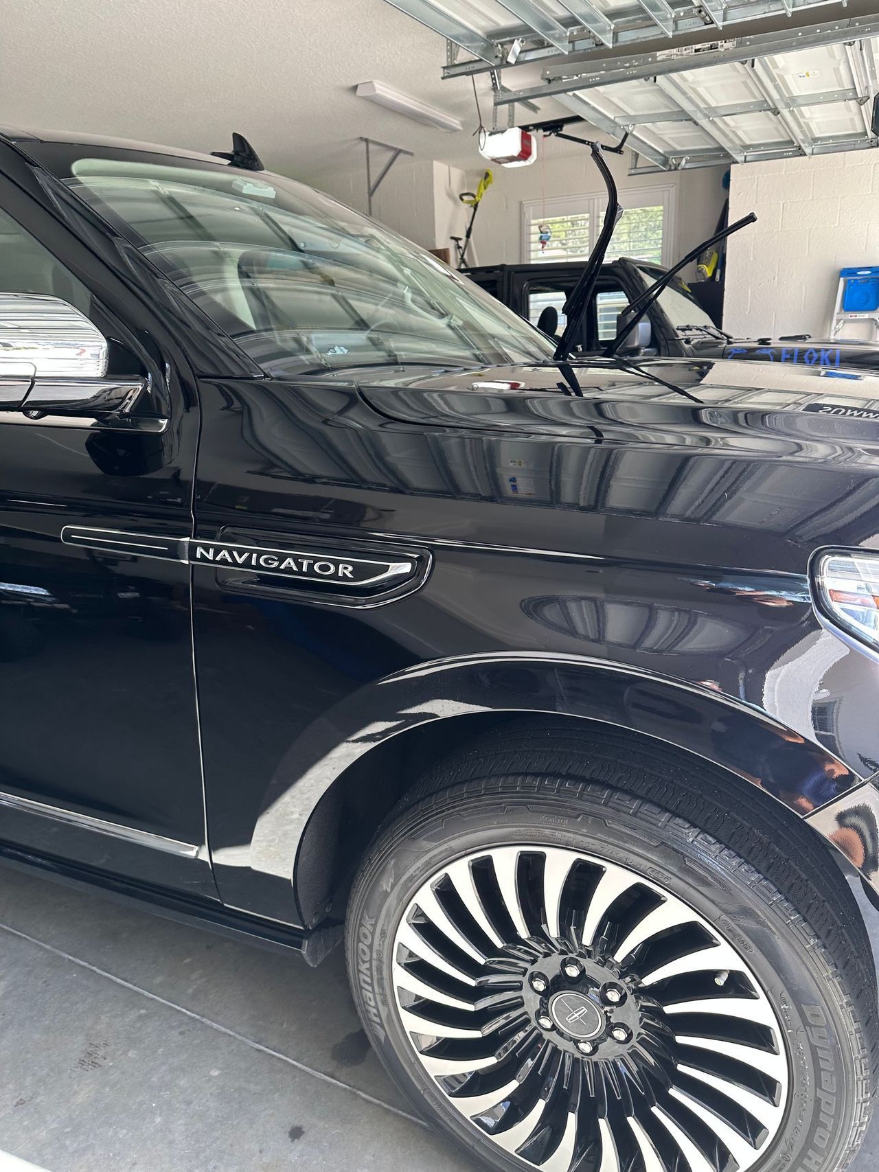 A black car is parked in a garage.