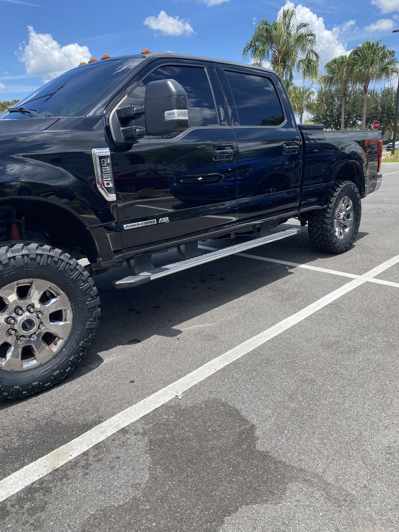 A black pickup truck is parked in a parking lot.