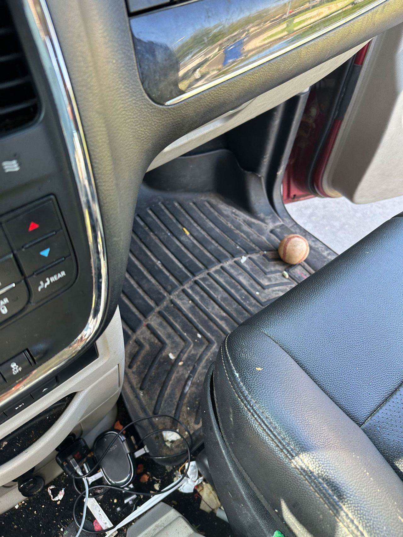 A ball is sitting on the floor of a car.