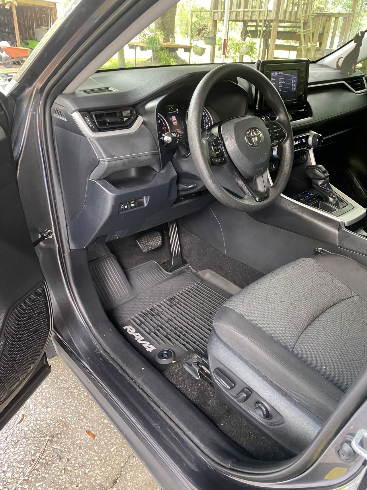 The interior of a toyota rav4 is shown with the door open.