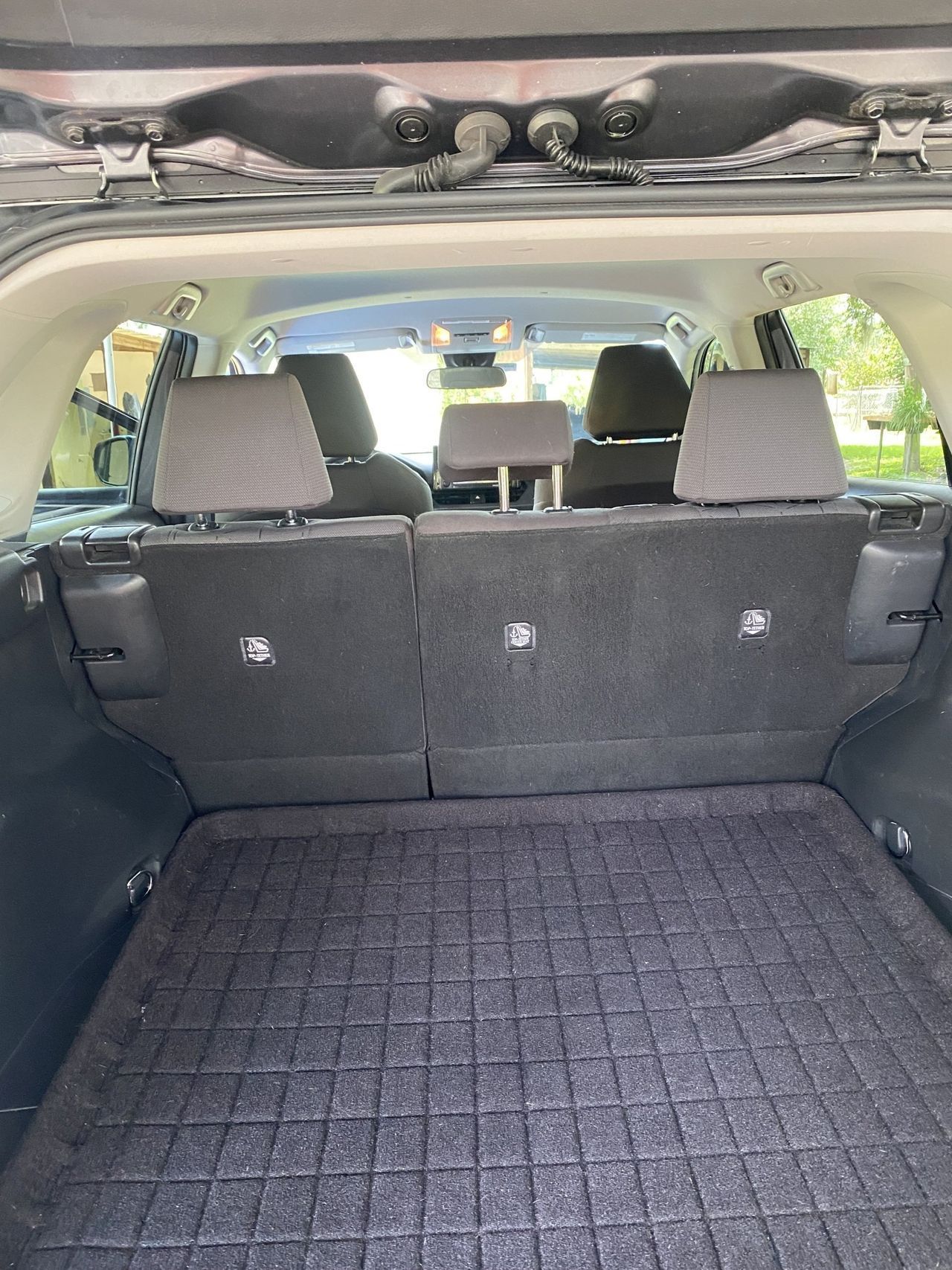 The back of a car with the trunk open and the seats folded down.