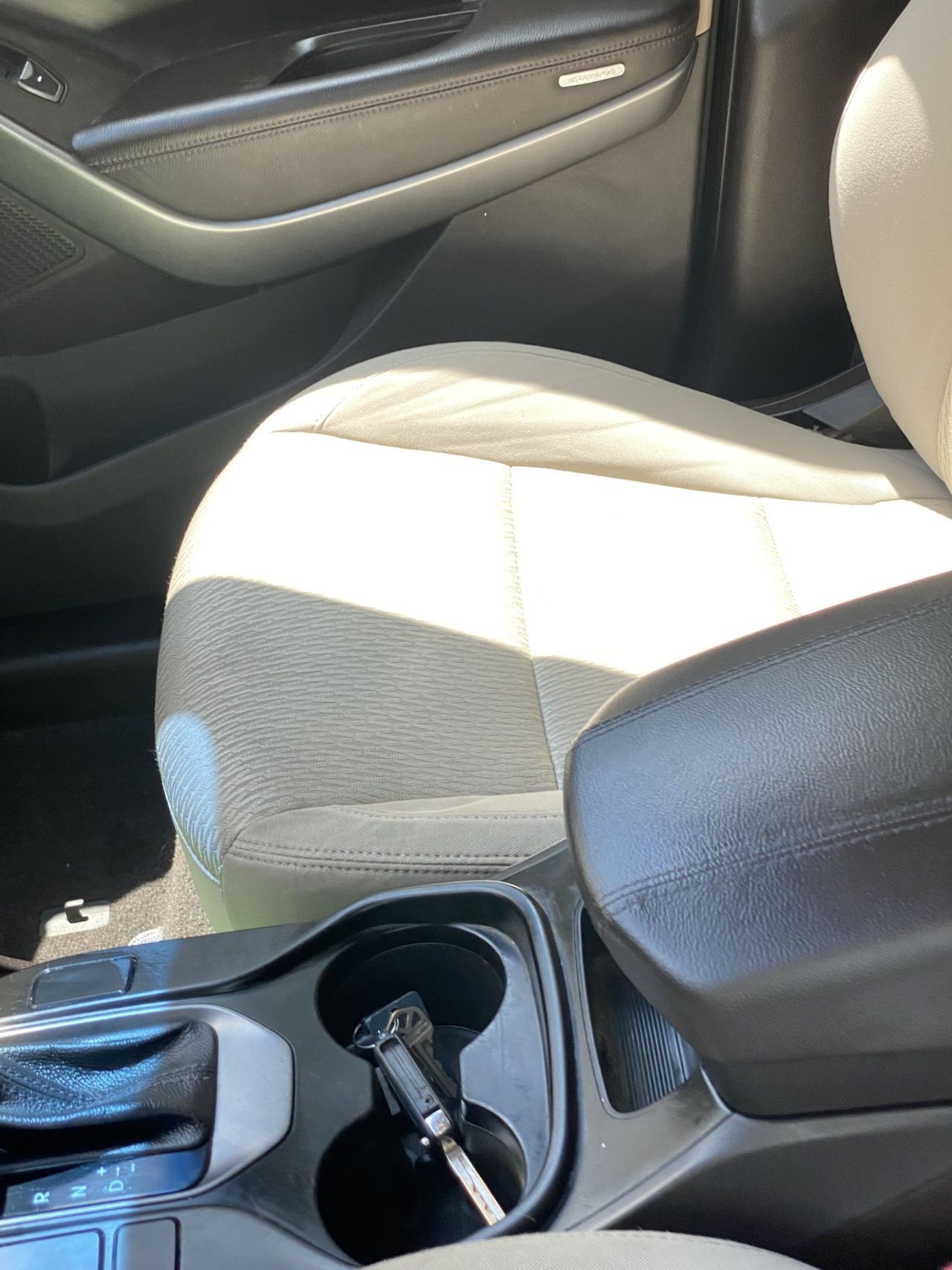 A car with a cup holder and a key in it