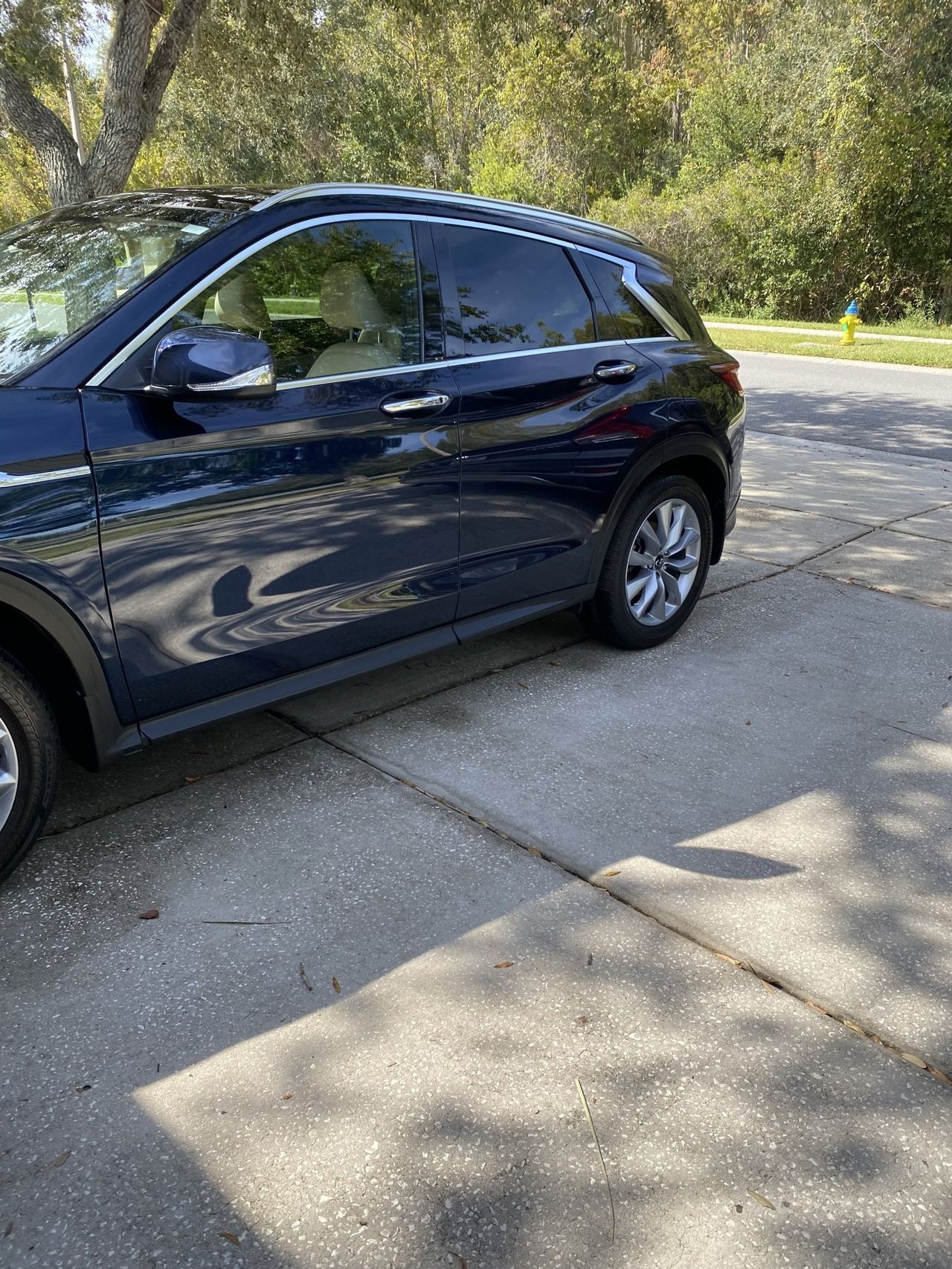 A black car is parked on the side of the road.