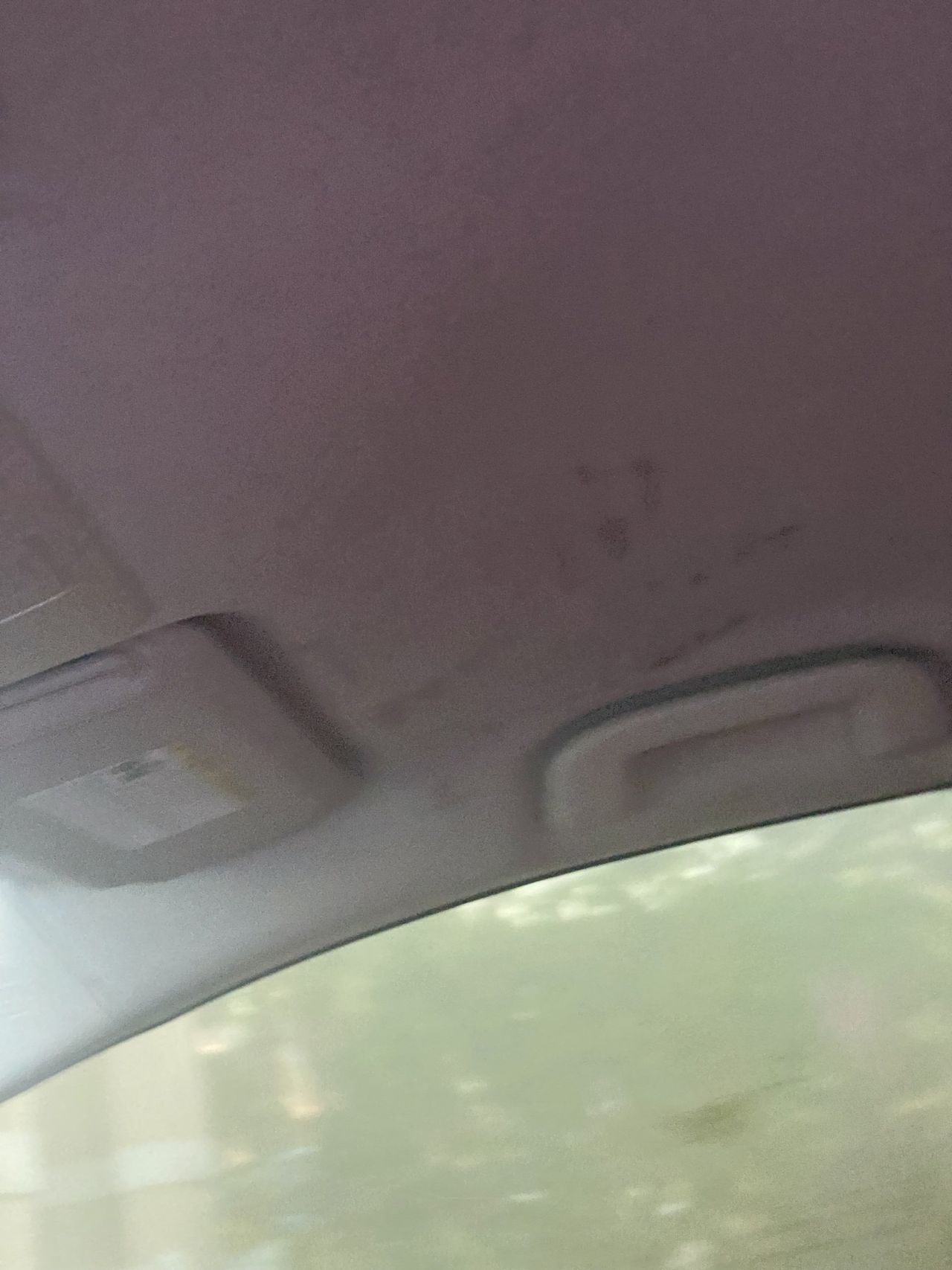 A close up of the ceiling of a car.