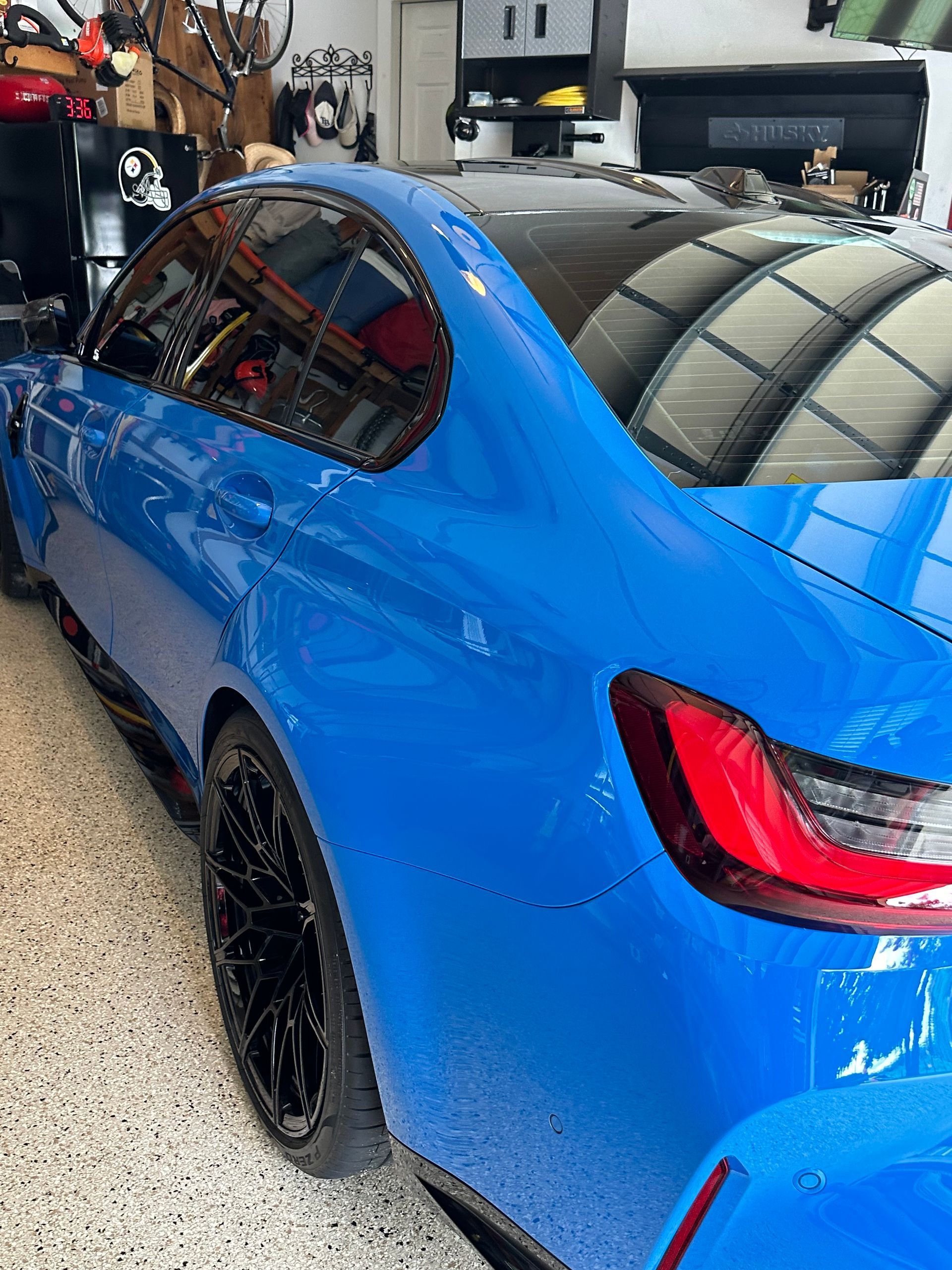 A blue car is parked in a garage.