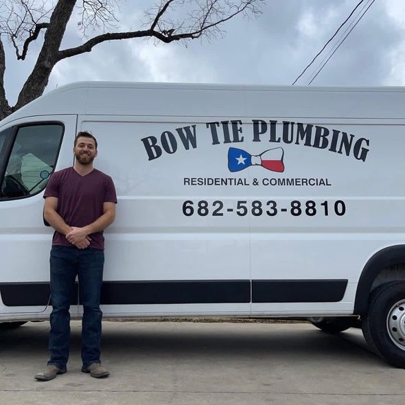 Man standing beside white Bow Tie Plumbing van with logo