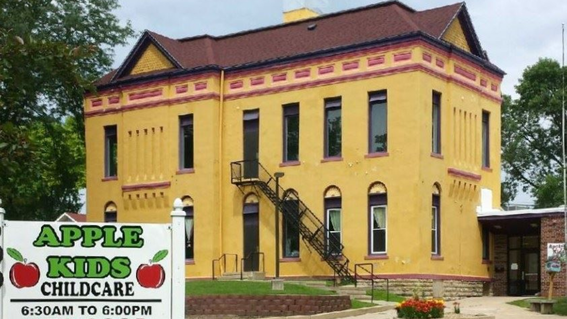 Yellow building with black fire escape,
