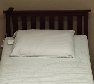 Bed frame with mattress and pillows