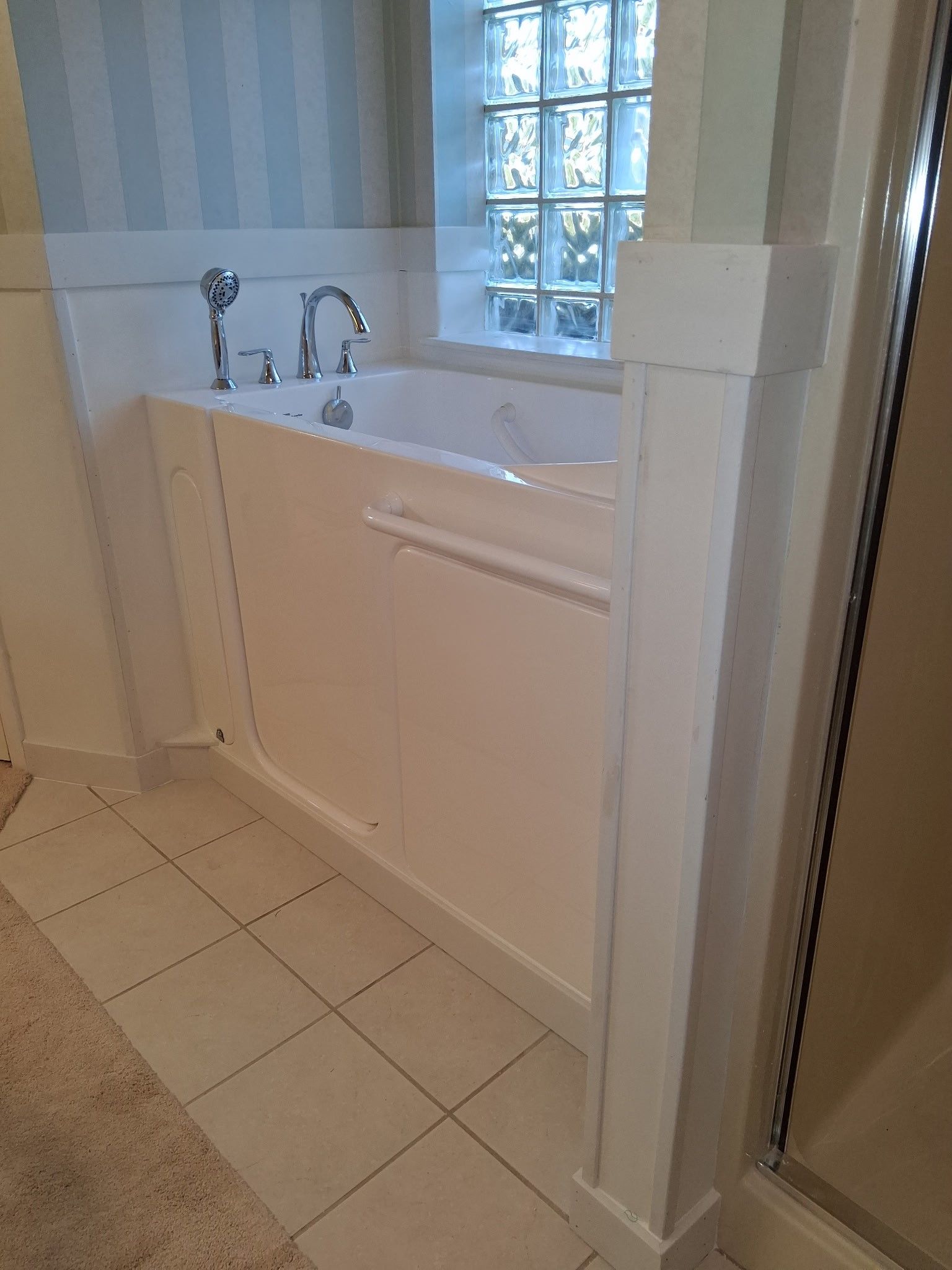 A bathroom with a bathtub and a shower.