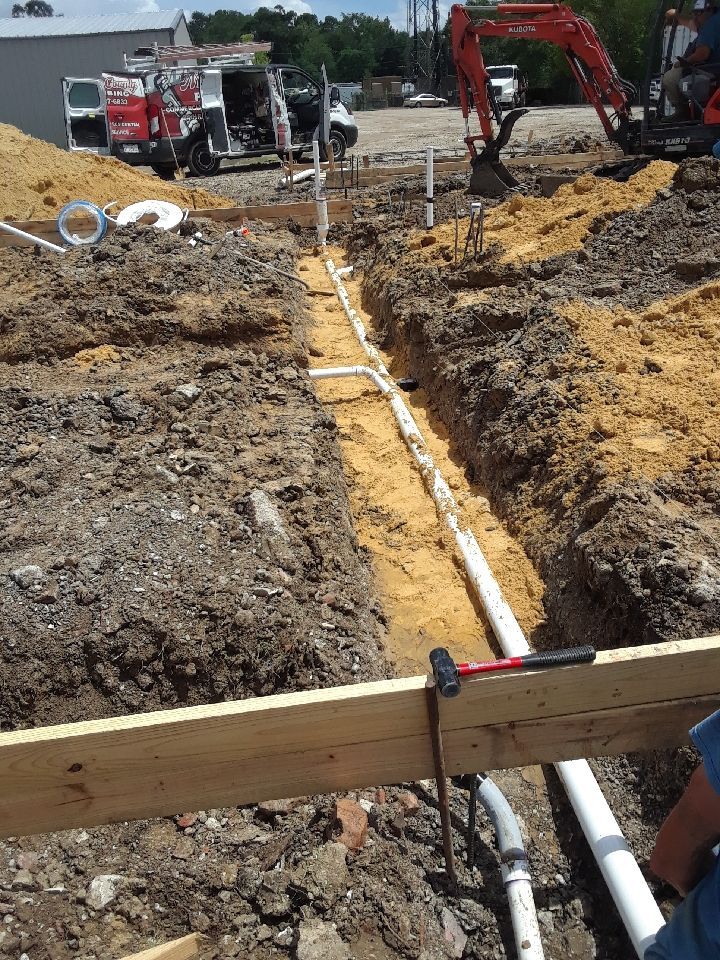 A construction site with pipes being installed in the dirt.