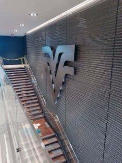 A staircase with a sign on the wall next to it.