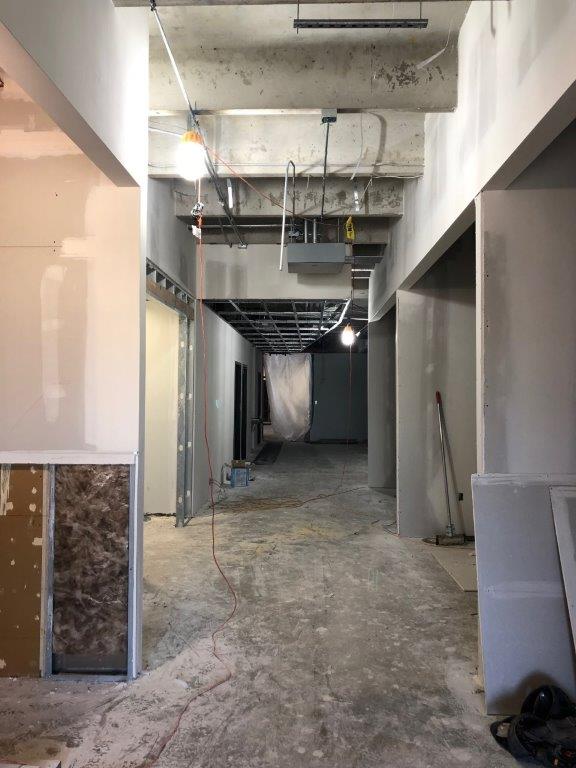 A long hallway in a building under construction.