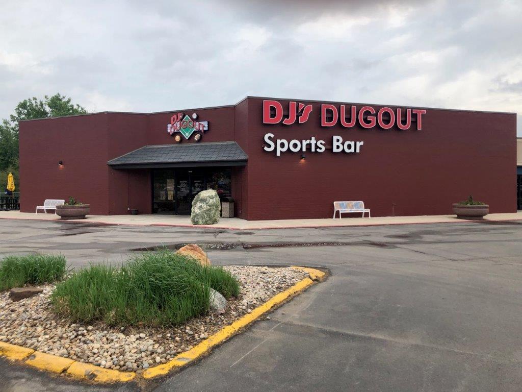 The dj dugout sports bar is located in a parking lot