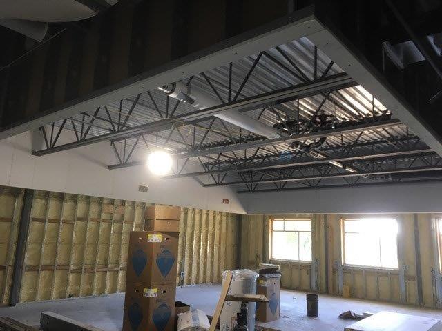A building under construction with boxes on the floor and a light on the ceiling