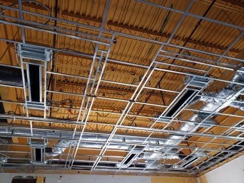 The ceiling of a building under construction with a lot of metal frames.