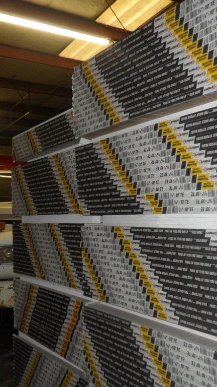 A warehouse filled with stacks of gypsum board
