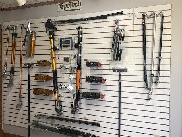 A wall with a lot of tools on it and a sign that says topetech
